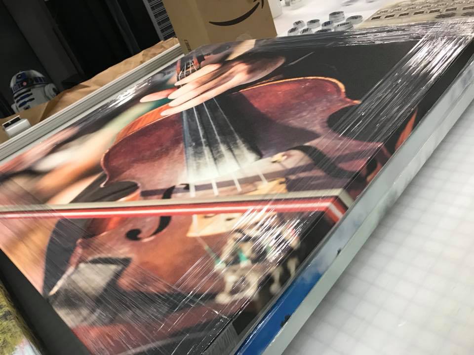 canvas sign of violin wrapped in plastic