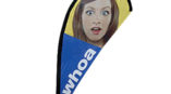 one teardrop banners on stand with an image of a womans surprised face