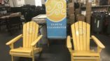 two yellow adirondack chairs in front of sign for St. Pete Clearwater