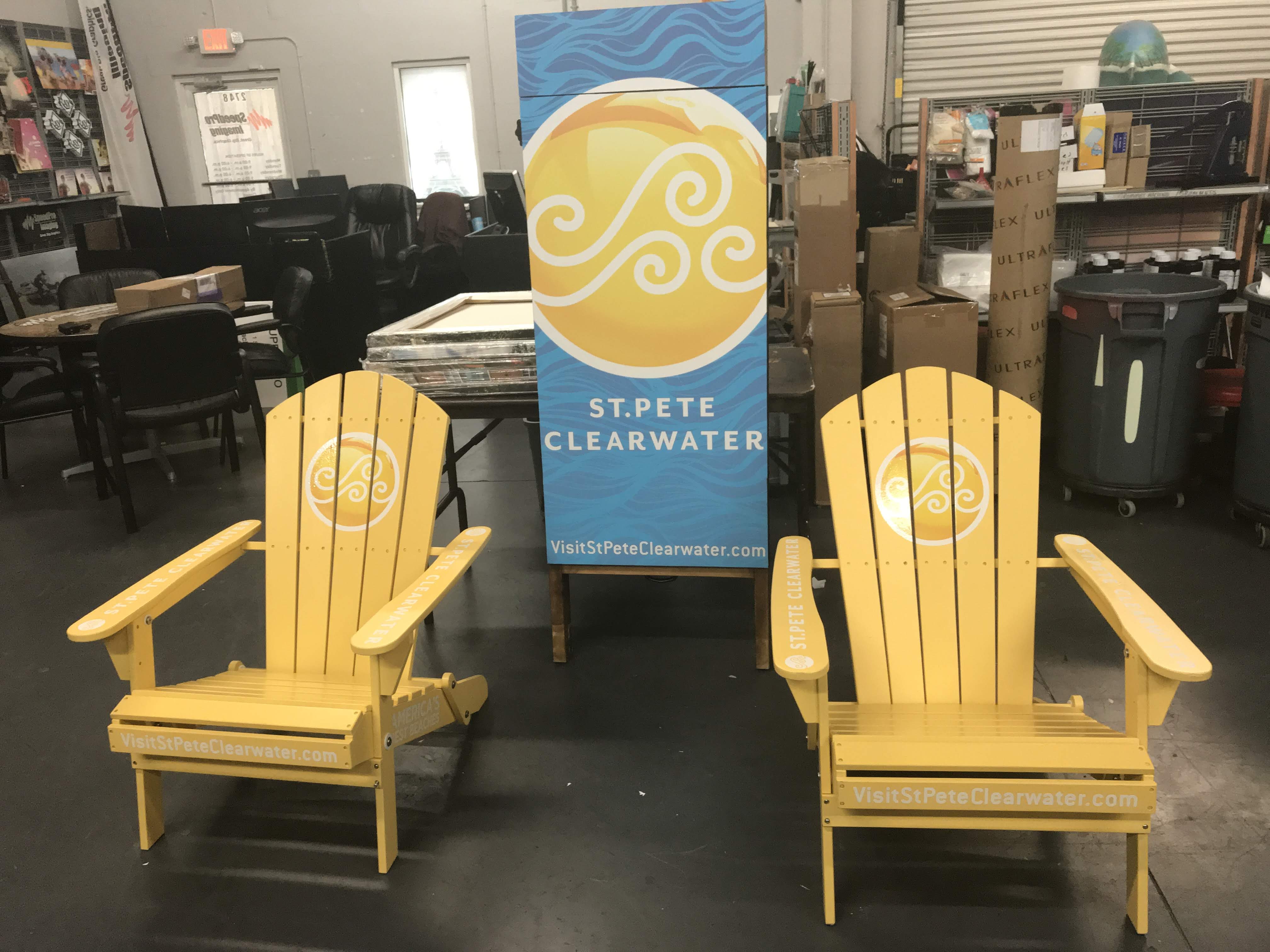 two yellow adirondack chairs in front of sign for St. Pete Clearwater