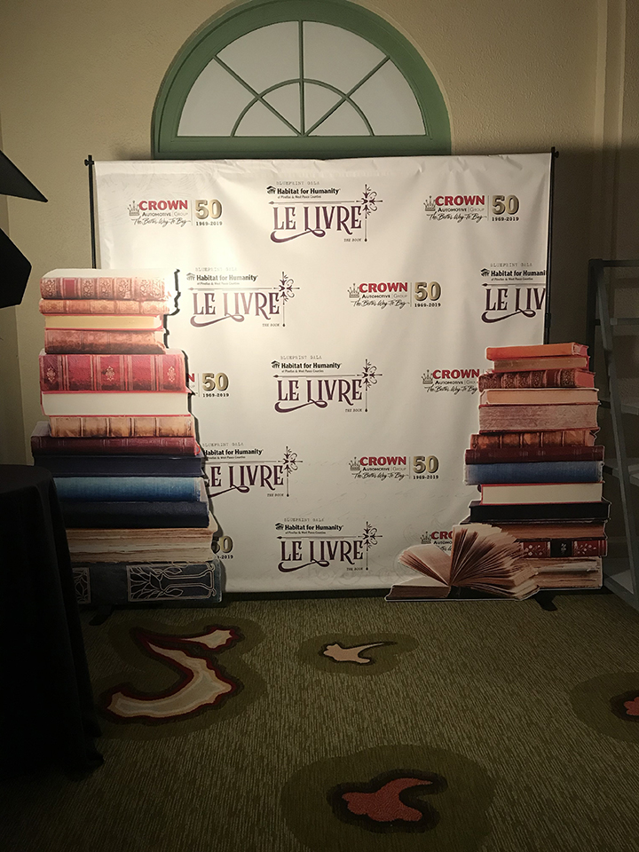step and repeat banner for Habitat for Humanity with large book cutout signs on the side