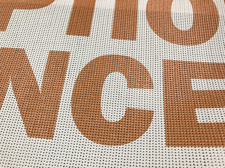 orange letters on cream colored mesh background