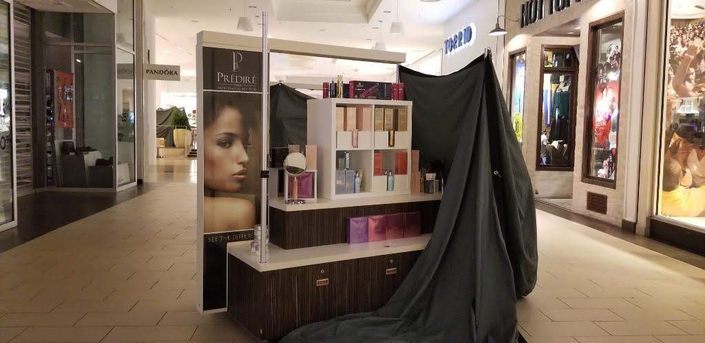 perfume booth in the mall with a tarp half covering it