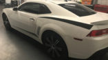 side view of white chevy camaro with black stripe
