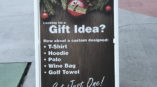 a frame sign outside outdoor shopping area promoting gift ideas