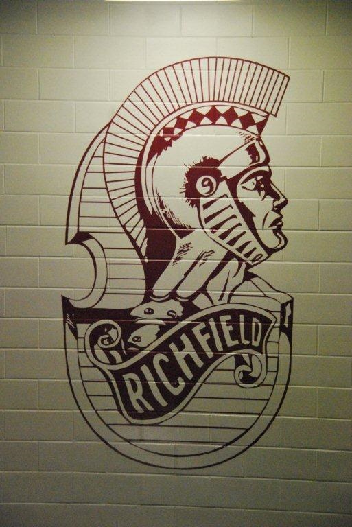 wall graphic of cartoon Roman man that reads 