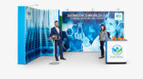 man and woman standing in front of BioMedics World Lab trade show display