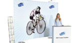 woman standing in front of cartoon man on bicycle on expolinc fabric system