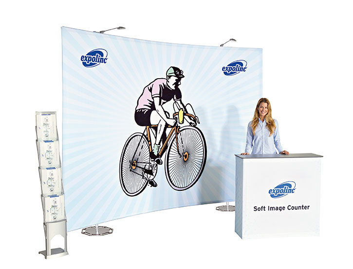 woman standing in front of cartoon man on bicycle on expolinc fabric system