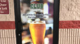 window door mural with large beer for Varsity Club