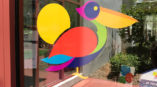 window graphic with colorful bird