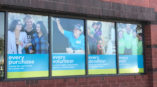 4 window murals with images of people volunteering