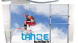 A twist lock display stand with an image of a snowboarder gliding through snow.