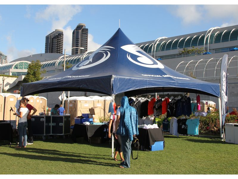 navy blue marquee tent with racks of clothing underneath