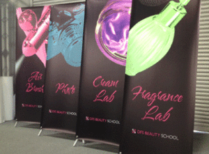 Non-retracting, "X-frame" banner stand and graphics for DFS Beauty School