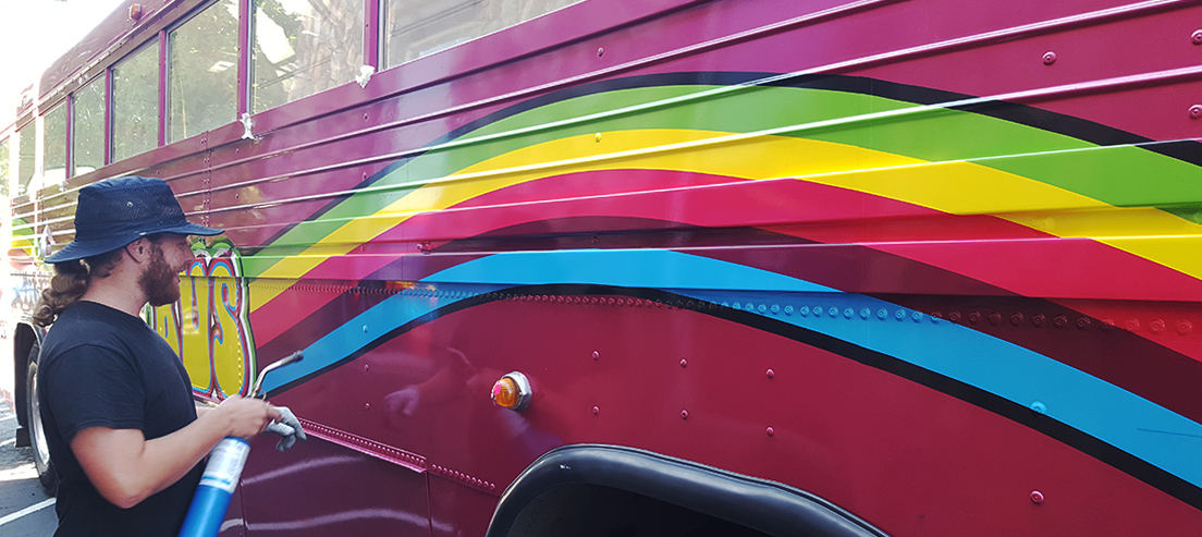 rainbow on side of purple bus