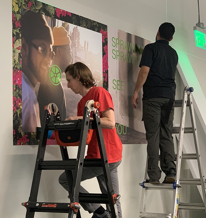 Men putting up lime wall posters