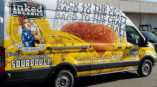 Inked organics van wrapped in advertisement for sourdough bread