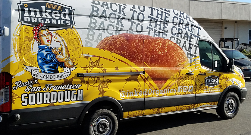 Inked organics van wrapped in advertisement for sourdough bread