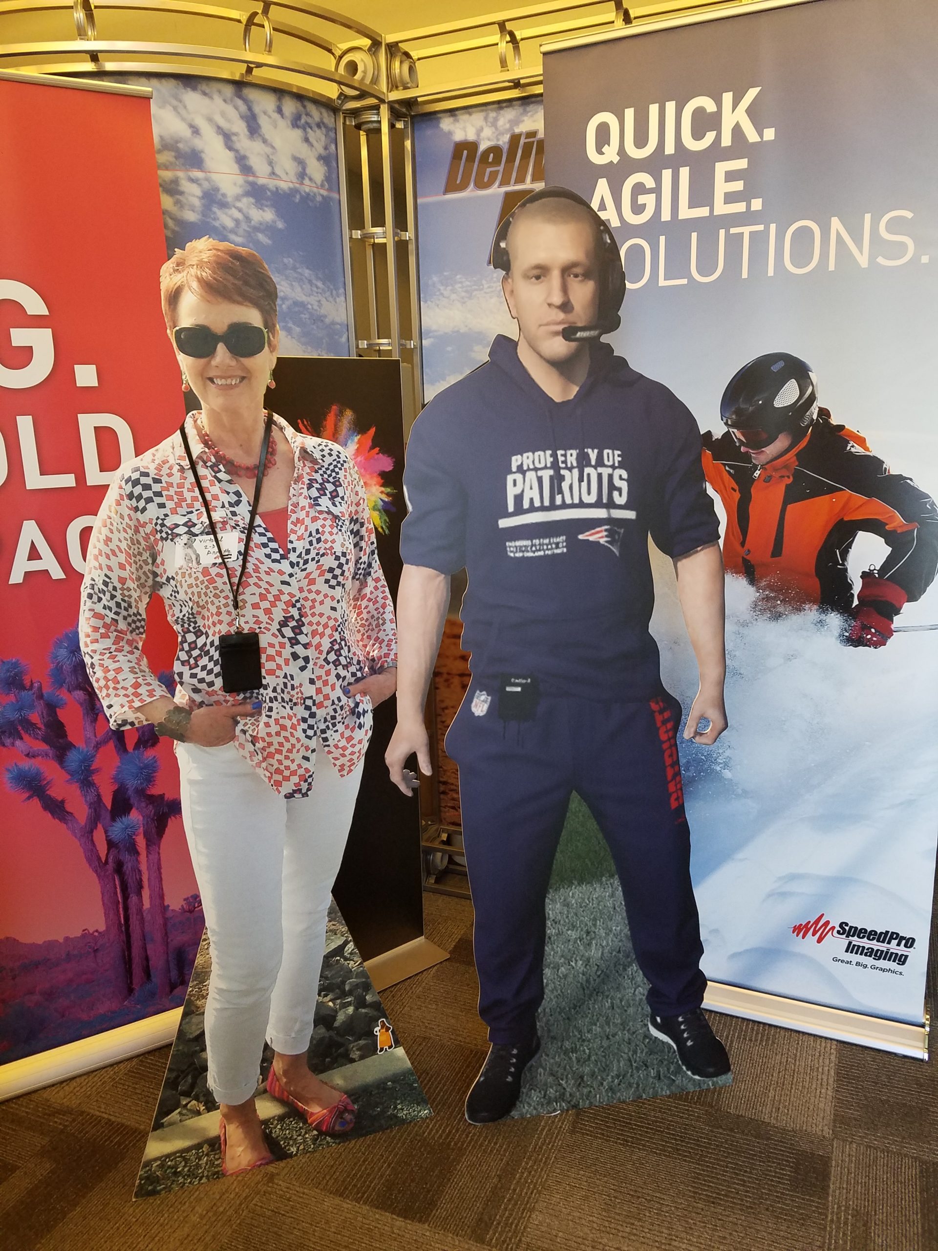 standing cardboard cutouts of patriots coach and a woman