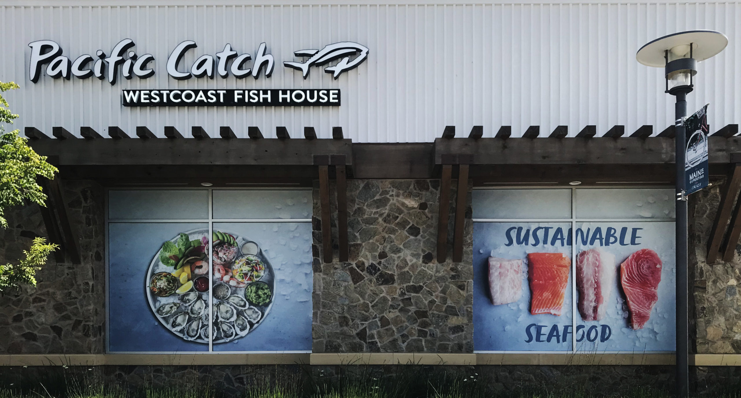 Pacific Catch west Coast Fish House windows wrapped with seafood pictures