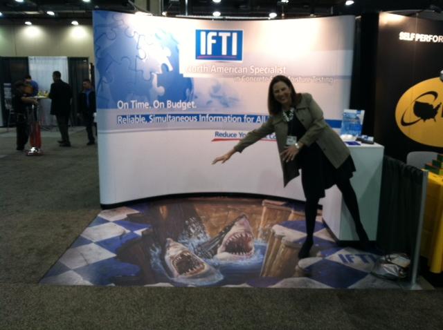 IFTI tradeshow booth with shark floor graphics