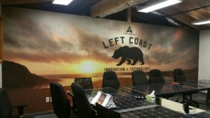 left coast innovation + technology beach background with logo in board room 