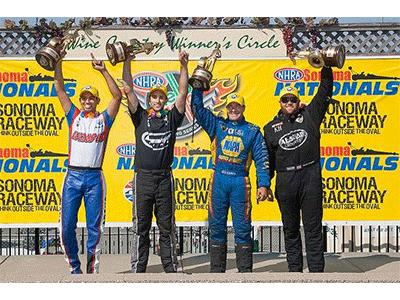 winners holding up trophy in front of sonoma nationals raceway signage