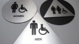 man woman and unisex bathroom sign circle and triangle 