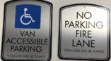 Wall signs for handicap accessible parking and no parking fire lane. 