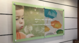 healing people transforming healthcare glass wall sign with a child
