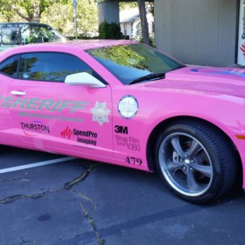 Hot pink vehicle wrap on sports car