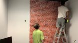 Brick wall graphic in office. 