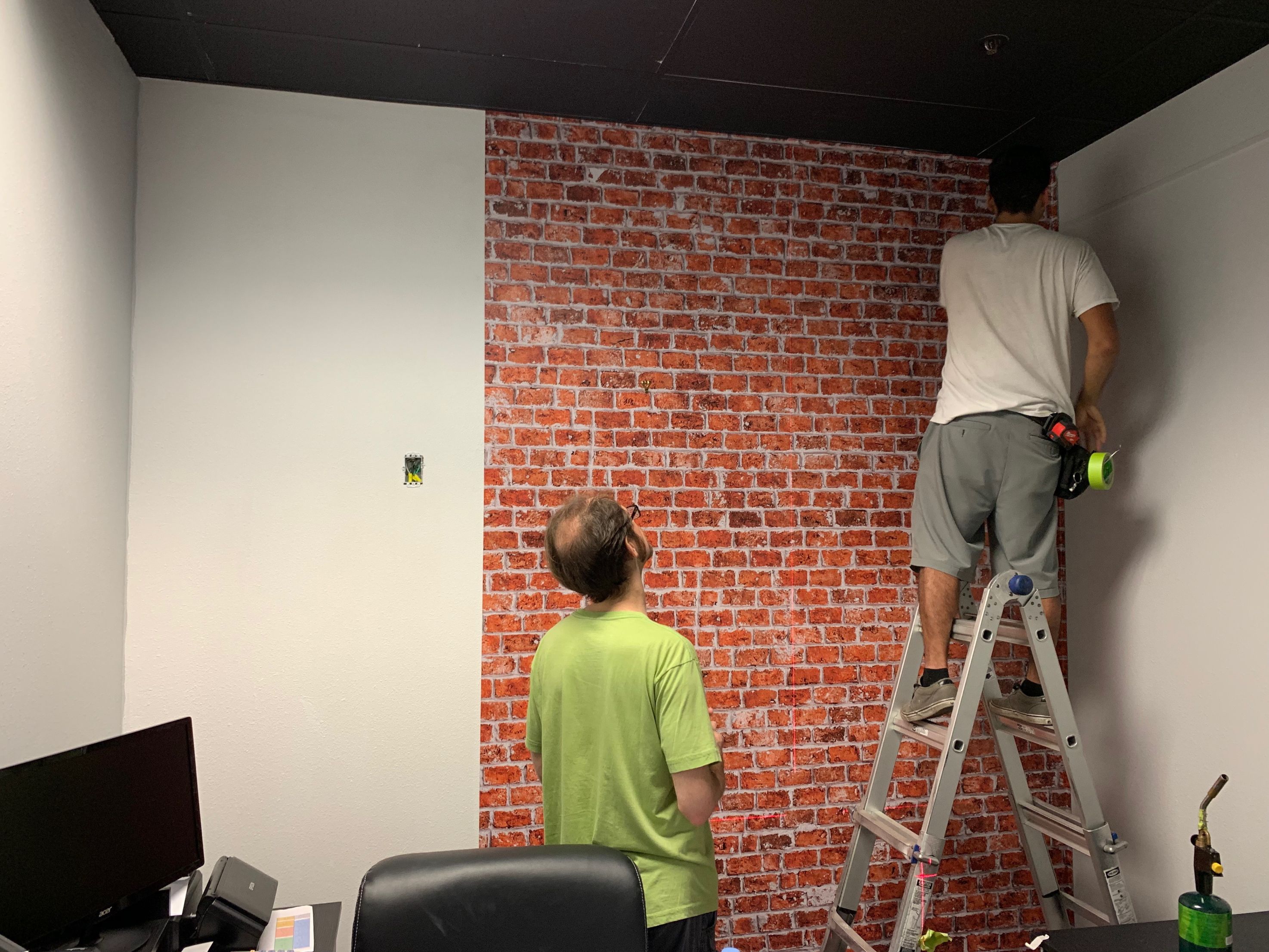 Brick wall graphic in office. 