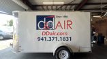 Custom cut vinyl trailer graphics for D&D Air featuring professionally installed commercial branding, logos, and contact information for mobile advertising.