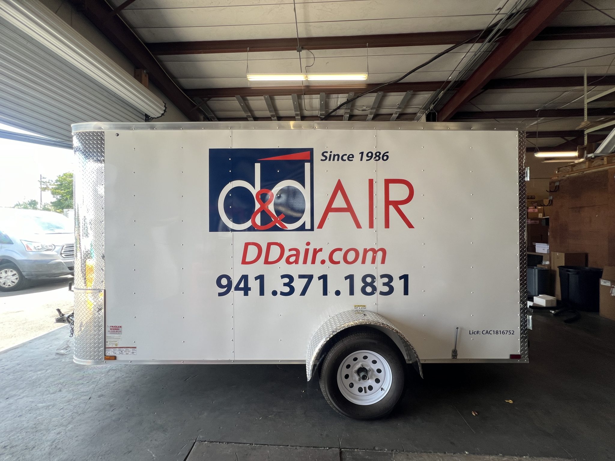 Custom cut vinyl trailer graphics for D&D Air featuring professionally installed commercial branding, logos, and contact information for mobile advertising.