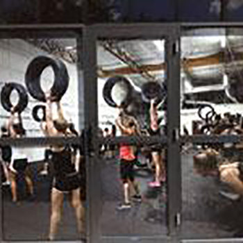 Window vinyl shows photo of an exercise class in session