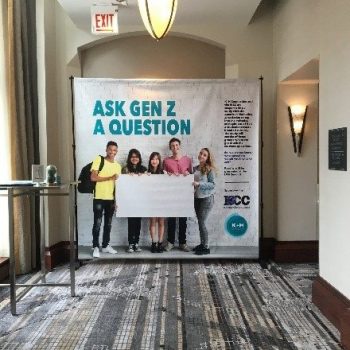 backdrop banner in a hallway that says "ask gen z a question"