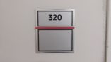Room sign that says 320 in braile