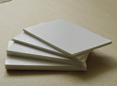 Blank white panels stacked on floor