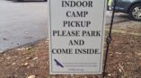Indoor camp pickup standing outdoor sign