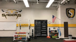 Sabers's weight room with decals on walls and door