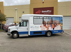 Colorful bus wrap showcasing a vibrant design on a land vehicle with prominent wheels