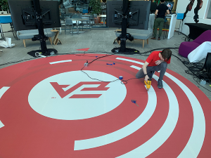 Artist applying street decal for EA Sports on colorful urban pavement