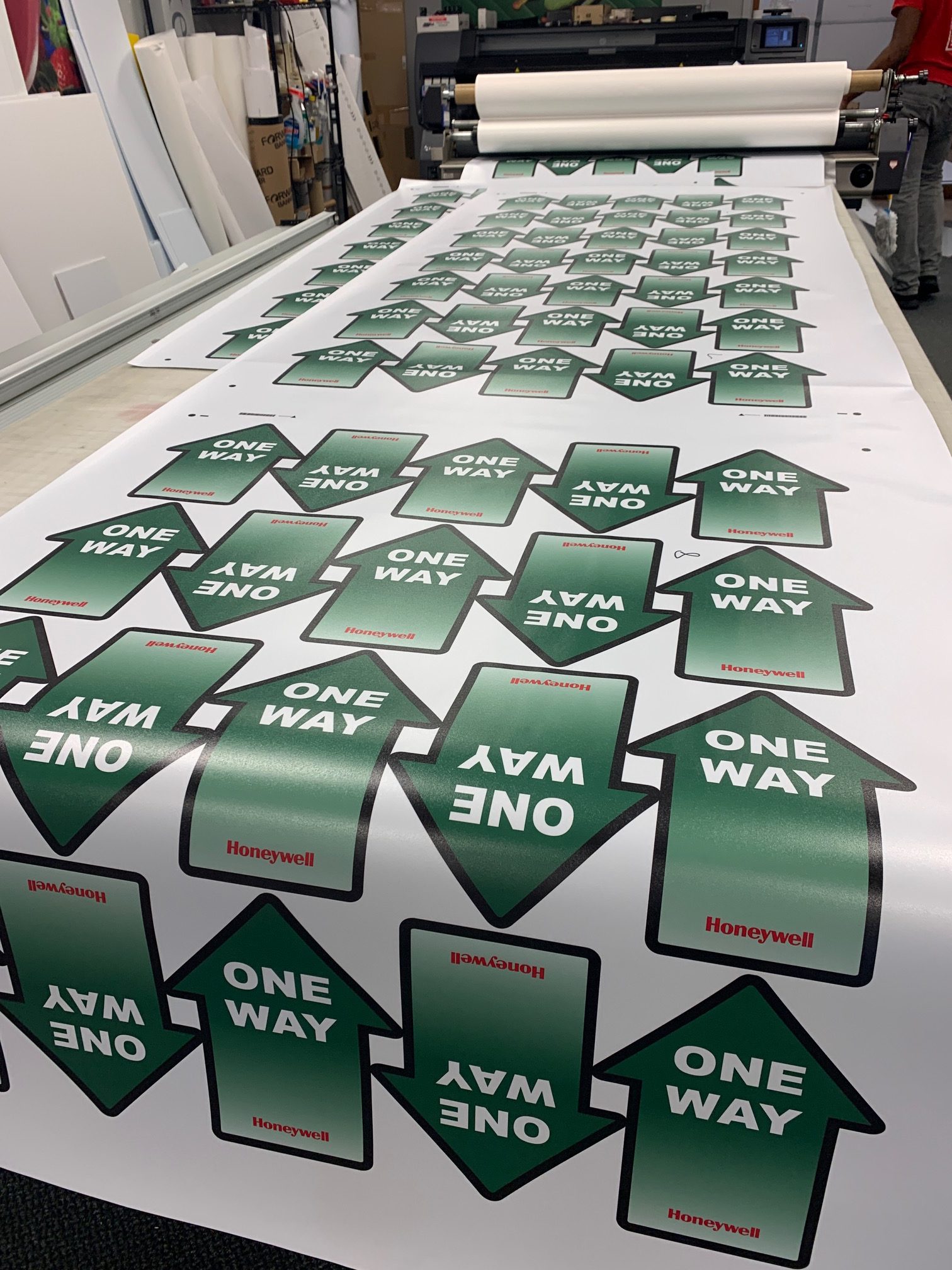 Paper advertising display featuring a green arrow graphic