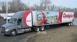 Eighteen-wheeler wrapped with graphics for the company Champion. 