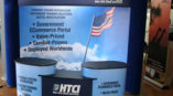 Custom tradeshow booth with graphics of HTCI logo and services. 