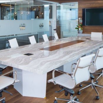 marble conference room table with stipe of opaque glass and logo in the back 