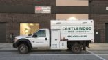 Vehicle decal on truck for Castlewood Tree Service outside of brick building 