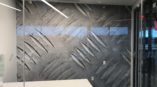 Wall mural of metal engravings in an office space created by SpeedPro 